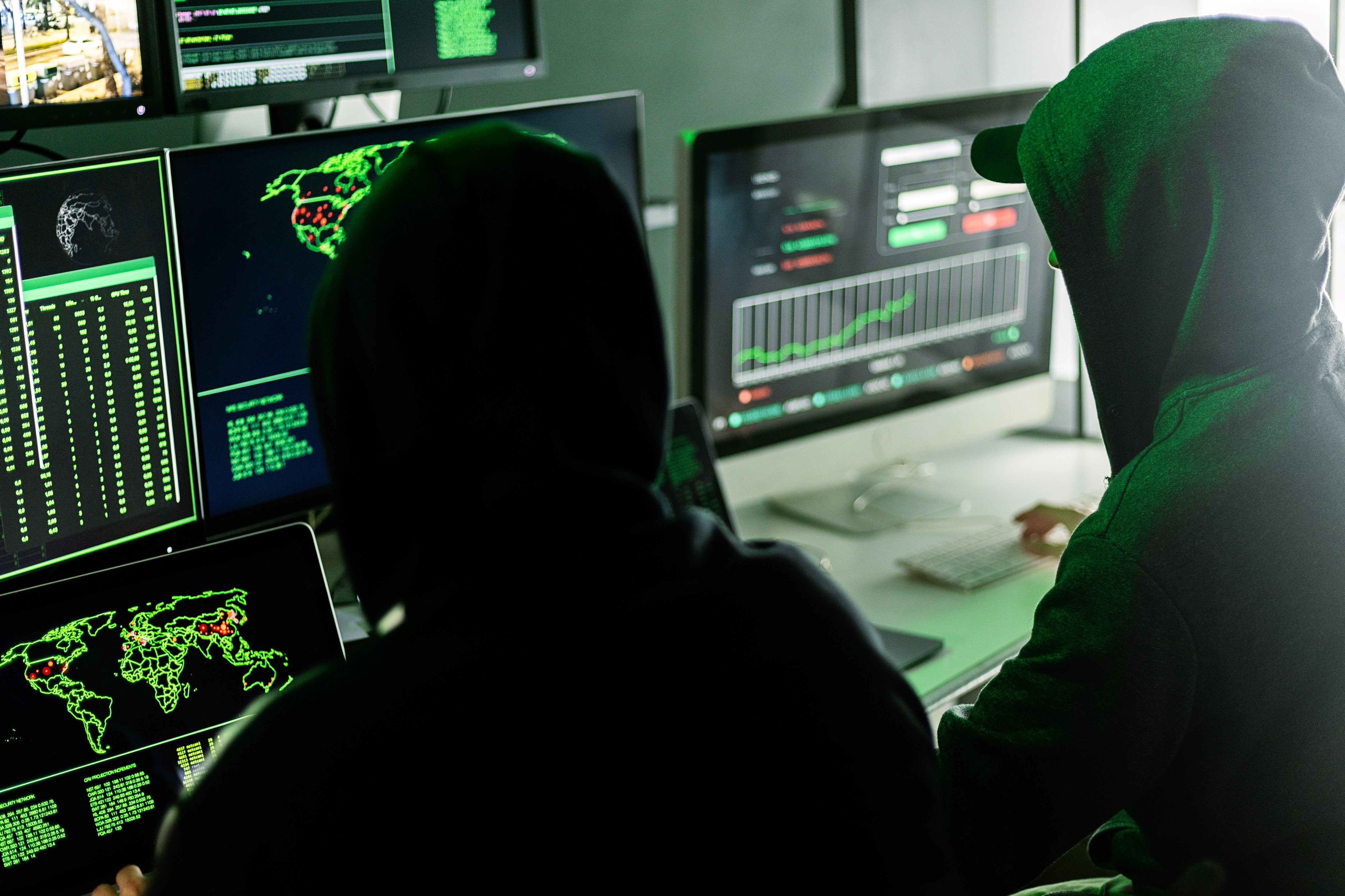 hooded-hackers-working-with-computer-data-2026-09-21-23-31-13-utc