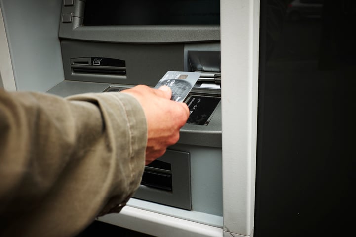 man-inserting-credit-card-into-automated-teller-2026-03-25-01-31-04-utc